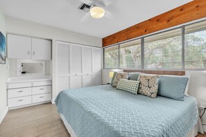 A bedroom with a bed, a wardrobe, a mirror, and a window with blinds. - Delightful 1-bedroom condo in sunny Sarasota on Golf Course (Sarasota)