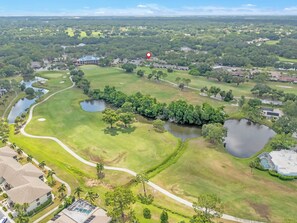 An aerial view of a golf course with multiple ponds, pathways, and residential buildings. - Delightful 1-bedroom condo in sunny Sarasota on Golf Course (Sarasota)