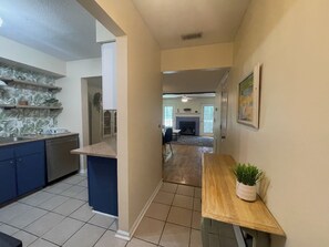 A kitchen with blue cabinets, a wooden countertop, and a potted plant. - Cozy 2-bedroom condo on St. Simons Island (St. Simons Island)