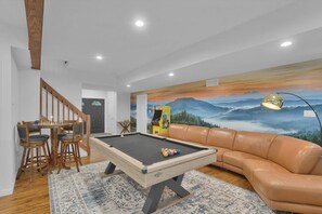 A pool table in a room with a sofa and a mural of a landscape. - Hot Tub, Luxe, Game Room, Open Concept, Privacy (Tobyhanna Township)