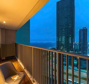 A balcony with a view of tall buildings and a cityscape at dusk. - @Discount 20% vith 1br &Sofa Bed #View Beach&city! (Đà Nẵng)