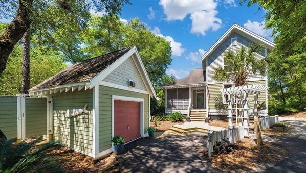 A residential property with a garage, a covered porch, and a small shed. - New to Market-Gorgeous 3 BR, sleeps 8, close to all, both clubs avail (Bald Head Island)
