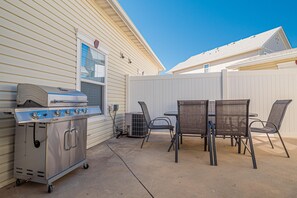 A patio with a grill, chairs, and a table. - Base Camp: Downtown Charm Dogs Welcome! (Fruita)