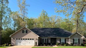 A single-story house with a garage, a front porch, and a lawn. - Fantastic Family-Friendly 4-BR house with AC  on 3 acres in peaceful WhiteHall. (White Hall)