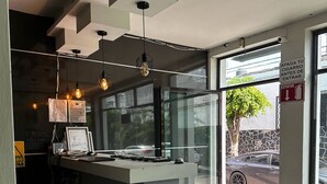 A modern interior with a central island, pendant lighting, and a view of the outside. - Hotel kristal (La Barca)