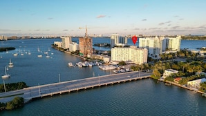 An aerial view of a coastal city with a bridge, marina, and high-rise buildings. - La Marinita, Quaint, Water Views Minutes to Beach (North Bay Village)
