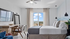 A bedroom with a bed, a desk, a chair, a TV, and a view of the outdoors. - Bayshore Bliss, Cozy With Water Views of Miami Bay (North Bay Village)