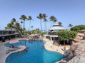 A pool area with multiple swimming pools, palm trees, and a gazebo. - Coastal Dreams, Serene, Beachfront With Pool (Miami Beach)