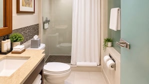 A bathroom with a shower, toilet, sink, and a towel rack. - HarbourtFront Center (Toronto)