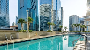 A swimming pool with clear blue water, surrounded by modern high-rise buildings. - Relaxing Cloud 9, Central Brickell Location (Miami)