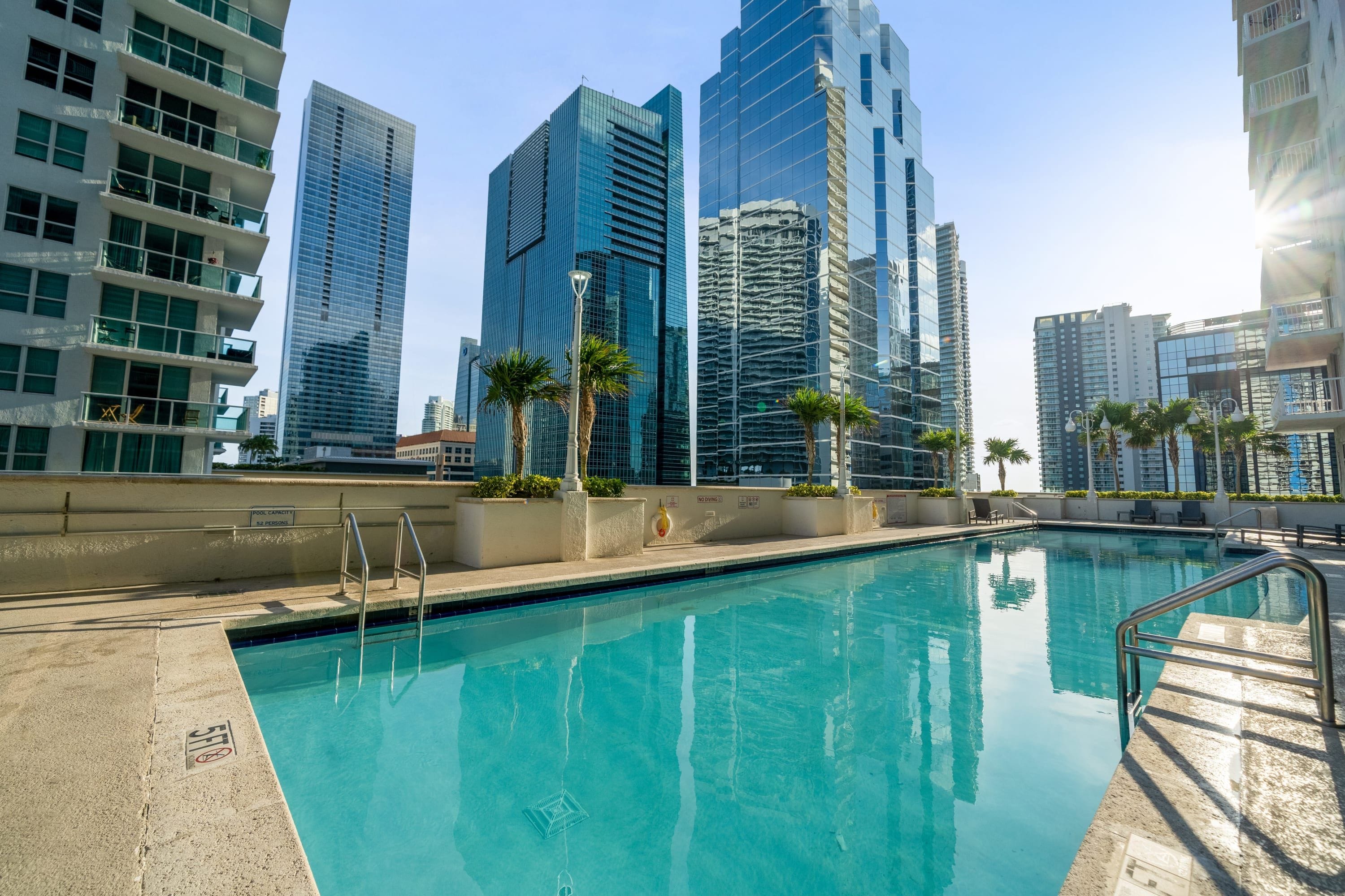 A swimming pool with a view of high-rise buildings in the background.