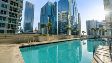 A swimming pool with a view of high-rise buildings in the background.