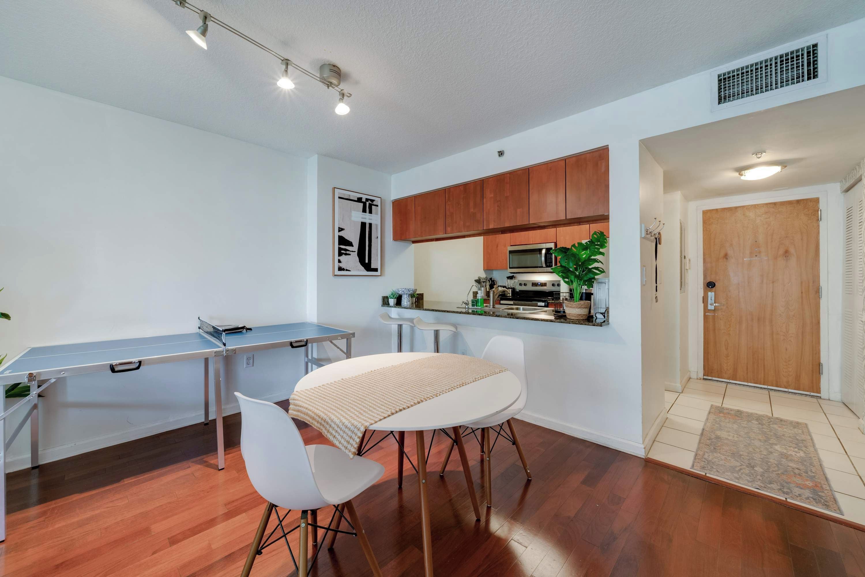 A compact kitchen with wooden cabinets, a microwave, and a sink.