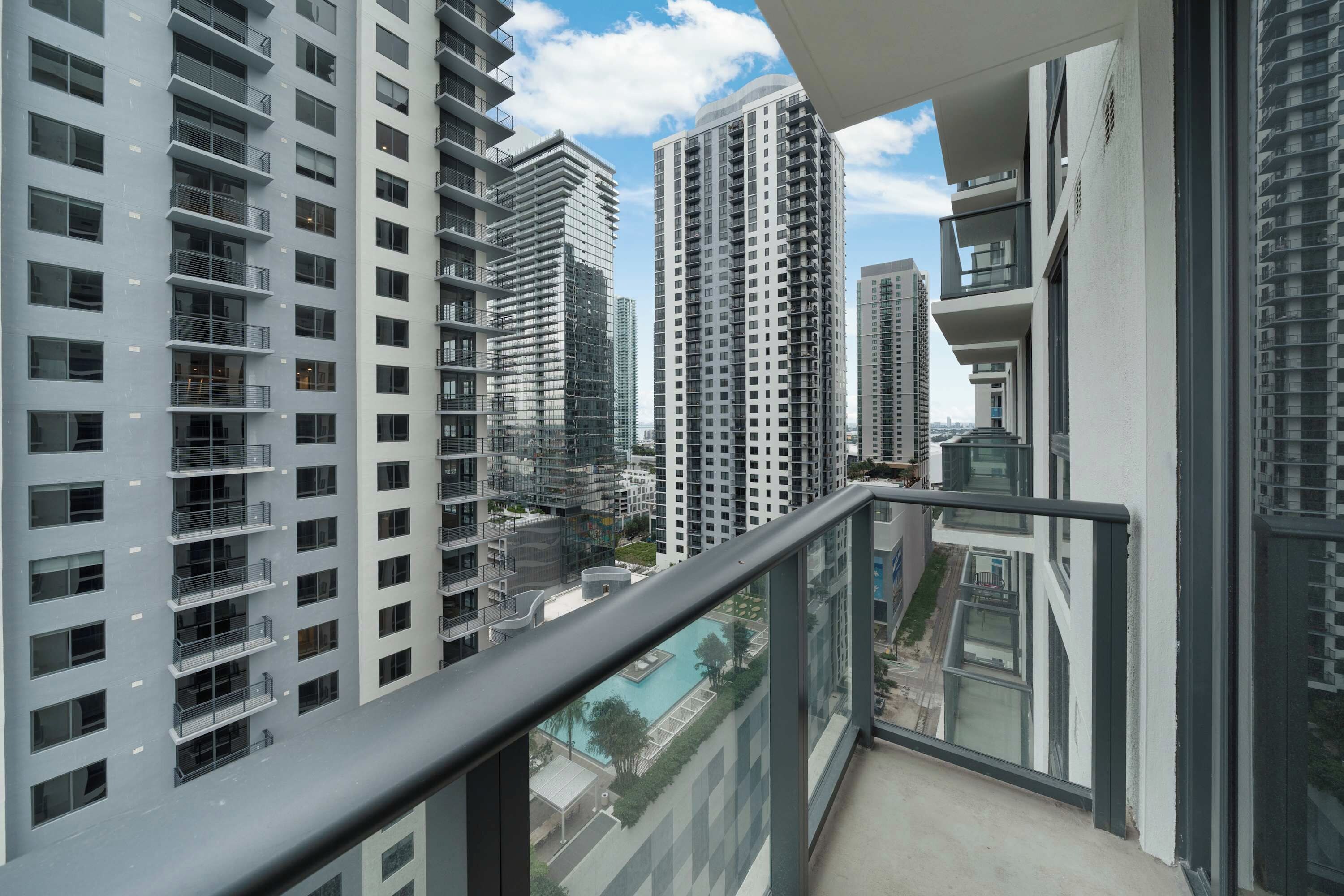 A high-rise residential building with multiple balconies and a clear view of the surrounding area.