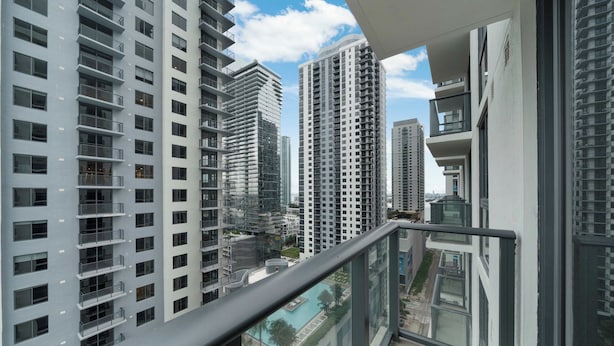 A high-rise residential building with multiple balconies and a clear view of the surrounding area. - Sky Sanctuary With Rooftop Pool & Hot tub (Miami)