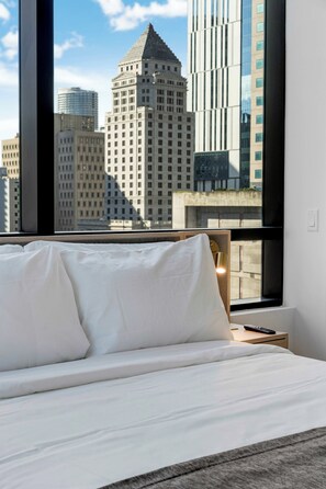 A hotel room with a large window offering a view of city buildings. - Downtown Edit Resort Style Stay With Lux Amenities (Miami)