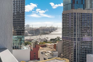 A high-rise building with a view of a port and cranes. - Aura Studio, Heart of Miami With Resort Amenities (Miami)