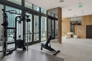 A gym with exercise equipment, large windows, and a spa area. - Brickell Skyline Pool, Gym, and Central Location (Miami)