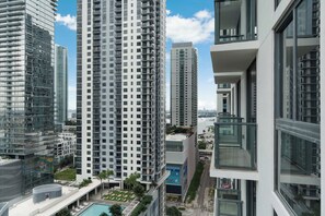 A high-rise building with multiple balconies and a pool area. - Downtown Collective - Pool, Rooftop Bar (Miami)