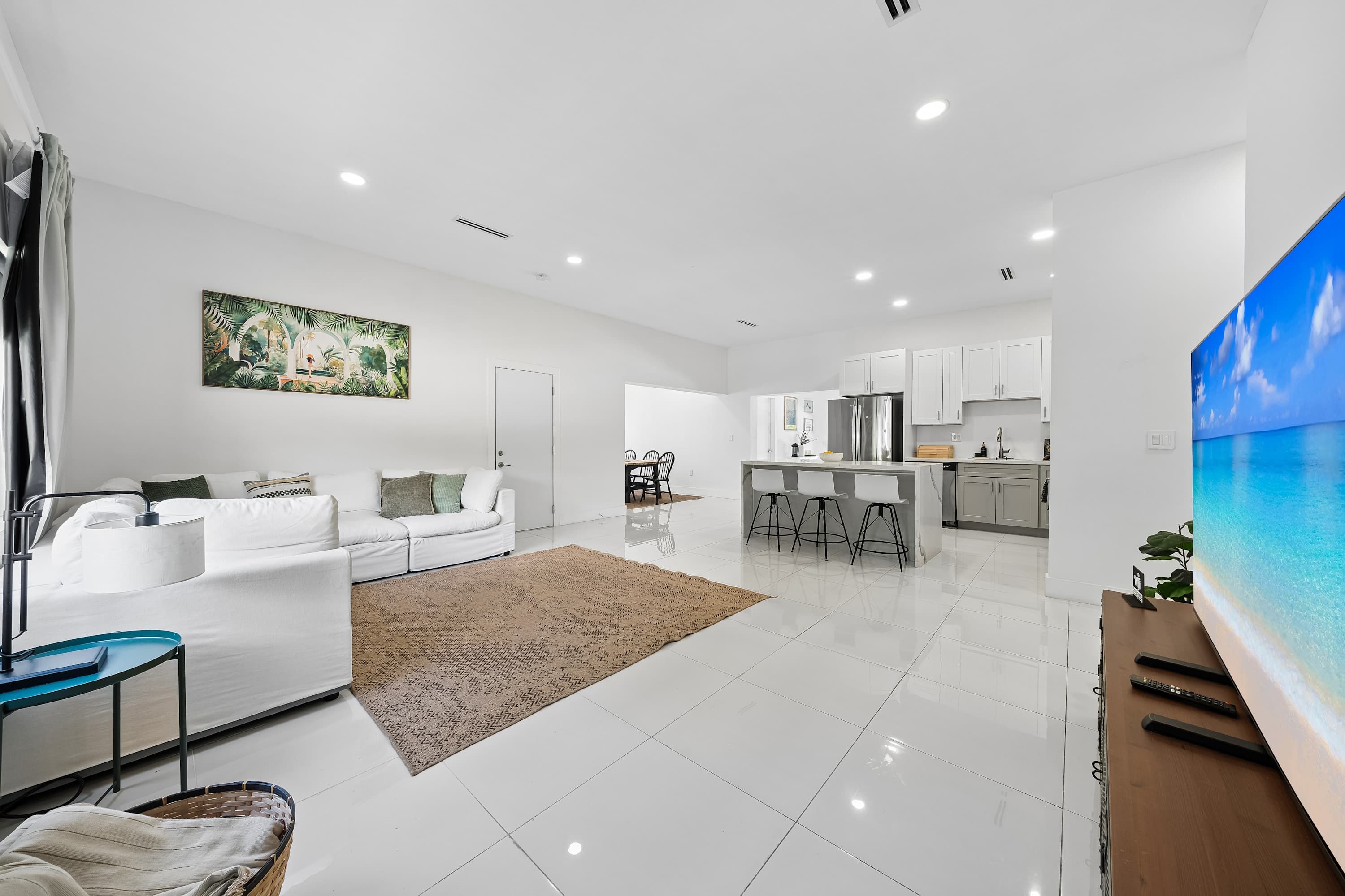 A modern apartment with a living room, kitchen, and dining area.