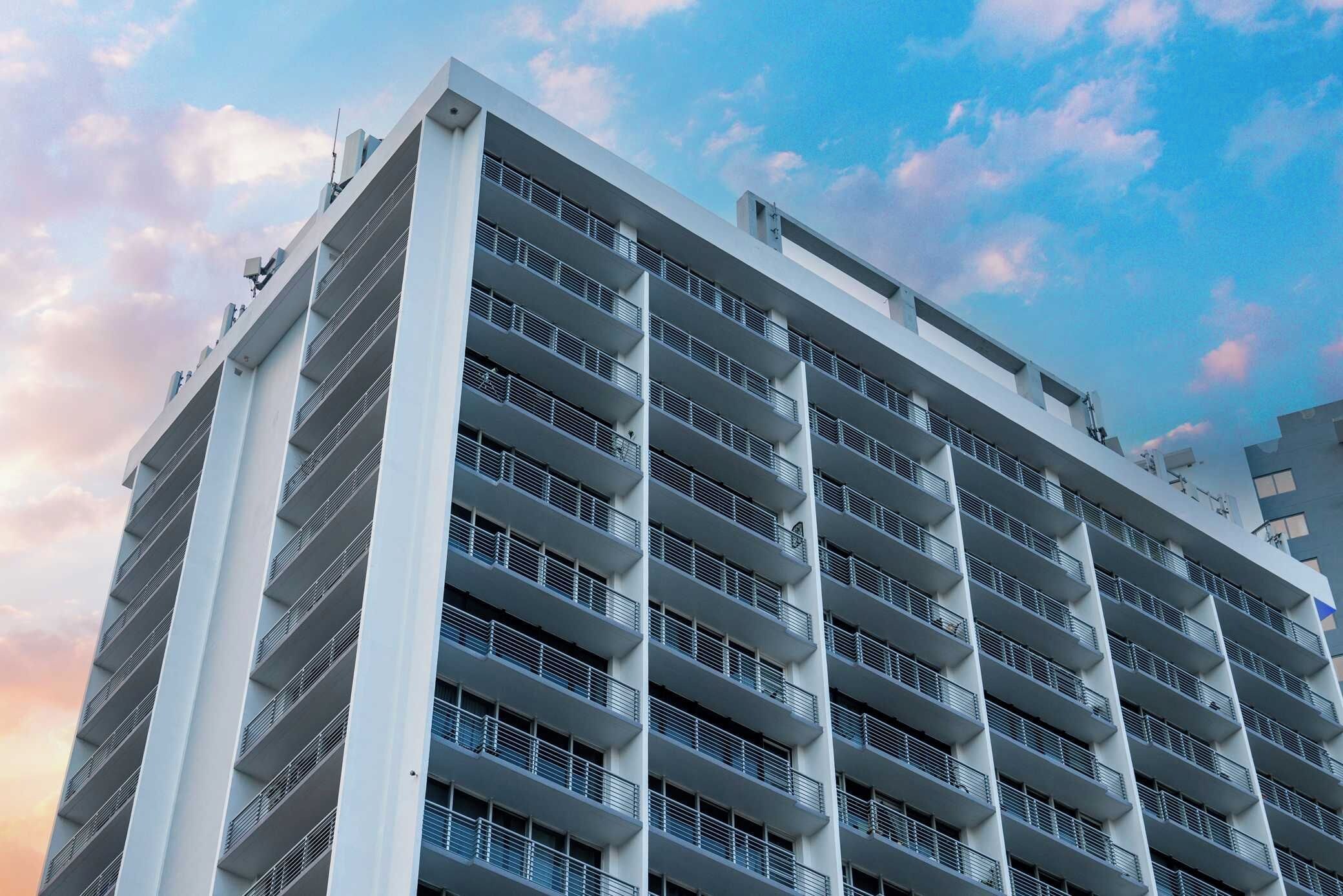 A multi-story building with balconies, likely a hotel or apartment complex.