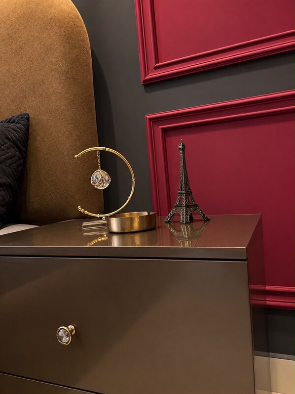 A dark brown chest of drawers with a gold-colored circular object on top.