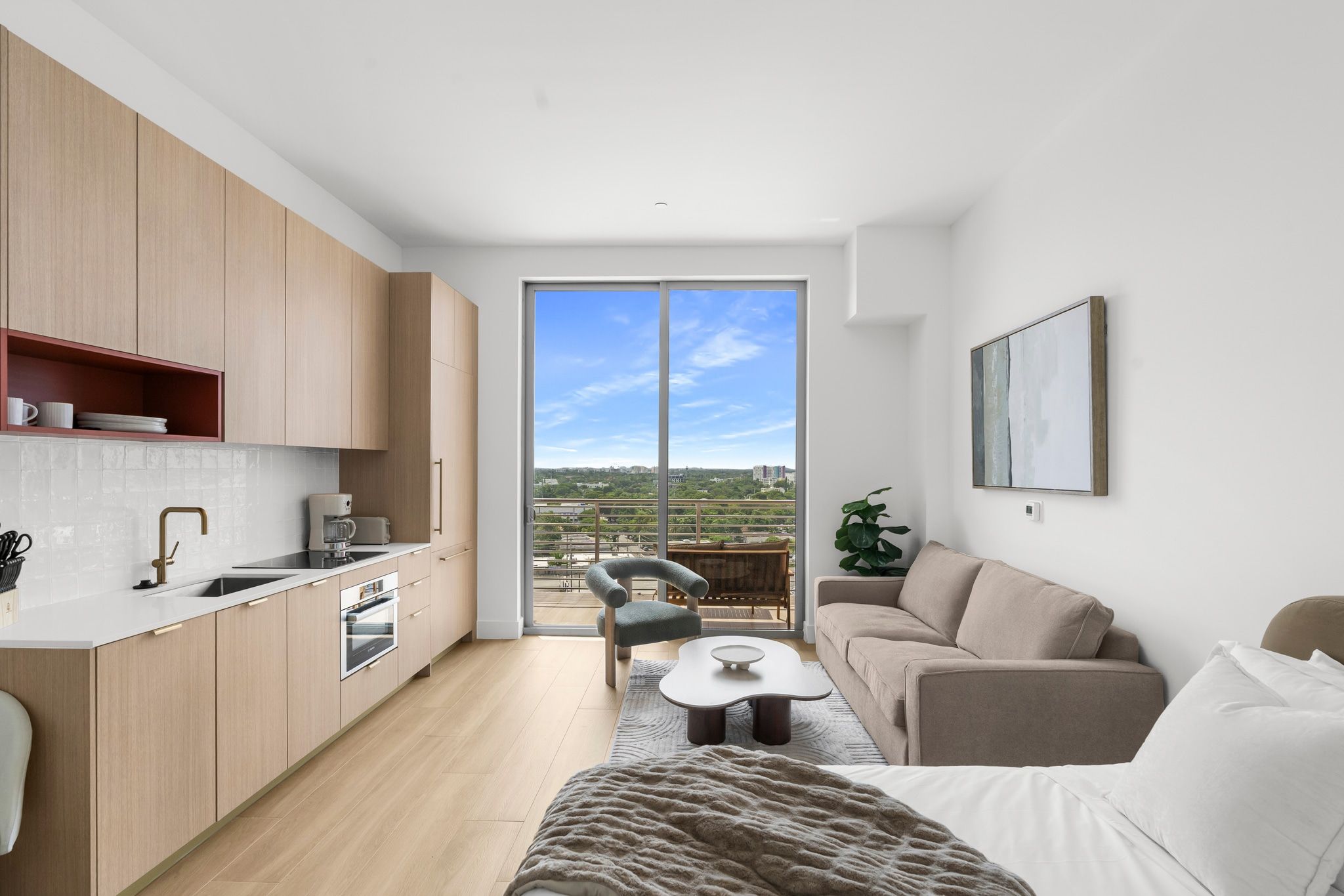 A modern apartment with a kitchen, dining area, and living room.