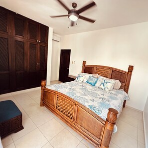 A bedroom with a bed, a ceiling fan, and a wardrobe. - Enjoyable Beautiful  oceanview first floor  apartment  in charming Cofresi (Cofresi)
