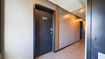 A hallway with a door labeled '204' and a door with a visible lock.