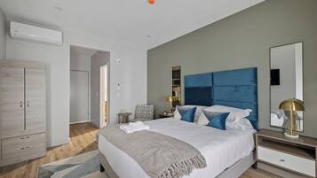 A bedroom with a bed, bedside tables, a wardrobe, and a mirror.