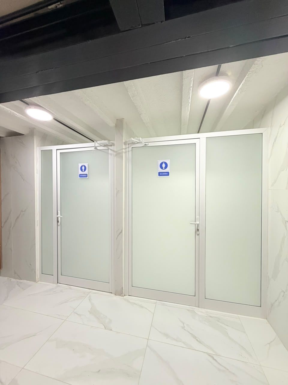 A restroom with two doors, each marked with a wheelchair accessibility sign.