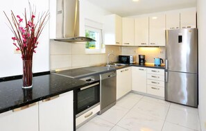 A modern kitchen with stainless steel appliances, a dishwasher, and a sink. - Nice home in Podstrana with private swimming pool, can be inside or outside (Podstrana)