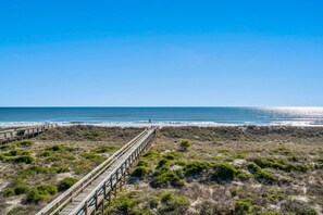A beach with a wooden boardwalk leading to the water. - Oceanfront 2BR • Pool • Walk Beach • Sleeps 6 (Fernandina Beach)