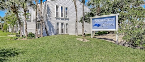 A two-story building with a sign reading 'Fernandina Shores.'