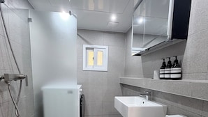 A modern bathroom with a toilet, sink, and shower. - Stay on you Gwangmyeong Station (Gwangmyeong)