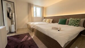 A hotel room with a large bed, a bedside table, a wardrobe, and a window with curtains. - Stay on you Gwangmyeong Station (Gwangmyeong)