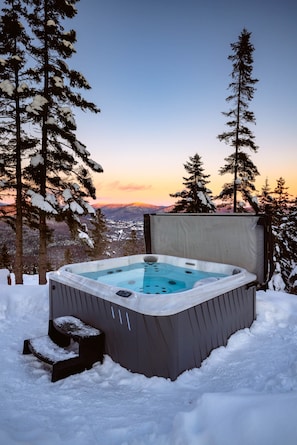A hot tub in a snowy outdoor setting with a view of mountains and trees. - BLACK MIRROR / Glass Retreat Above the Mountains (Capitale-Nationale)