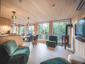 A modern interior with a dining area, seating, and a fireplace.