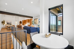 A modern interior with a dining area, kitchen, and living space. - Luxury Old Town Retreat | Walk to Town Lift & Main Street | Private Hot Tub (Park City)
