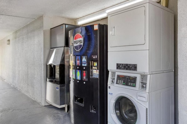 A vending machine and a washing machine in a public area.