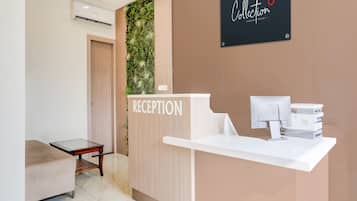 A reception area with a reception desk, a sign reading 'RECEPTION', and a wall-mounted sign above the desk.