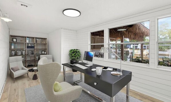 A modern office space with a desk, computer, and seating area. - Canal Front Tiki Bar & Pool 2 boat Docks Sleeps 11 (Hudson)