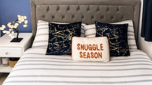 A bedroom with a tufted headboard, a framed artwork on the wall, and a pillow with 'SNUGGLE SEASON' text. - Room-cozy En-suite Room Netflix, Fast Wi (Wolverhampton)