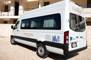 A white van with 'SAMSARA BY RARE EARTH' branding, parked in front of a building with a stone facade. - Calakmul: Intimate 2BR w/ Private Plunge (Tulum)