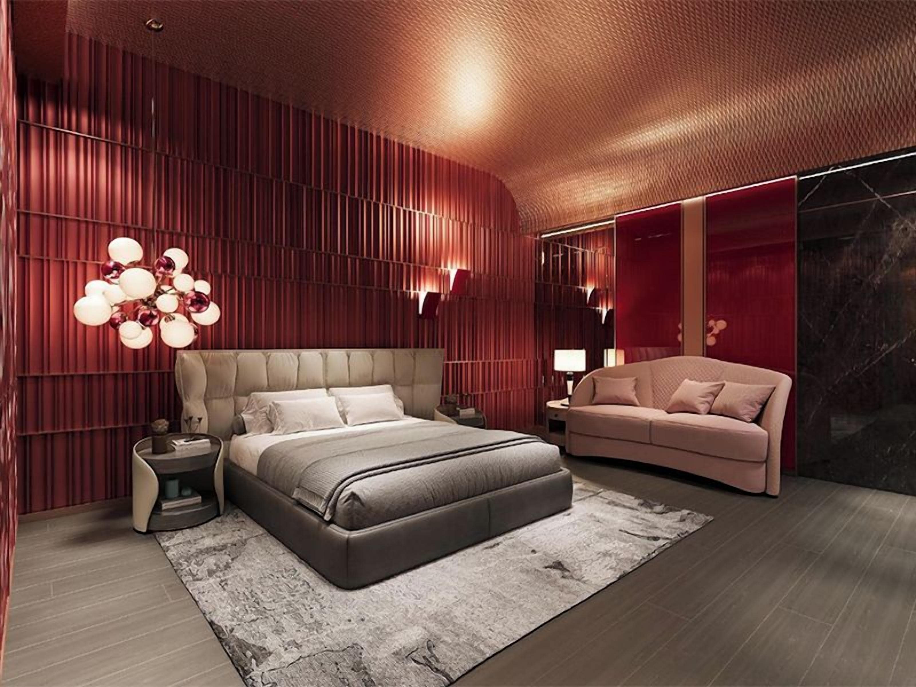 A modern bedroom with a large bed, a sofa, and a unique wall design.