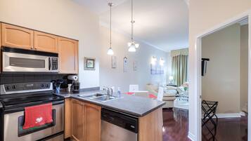 A modern kitchen with stainless steel appliances, wooden cabinets, and a central island.