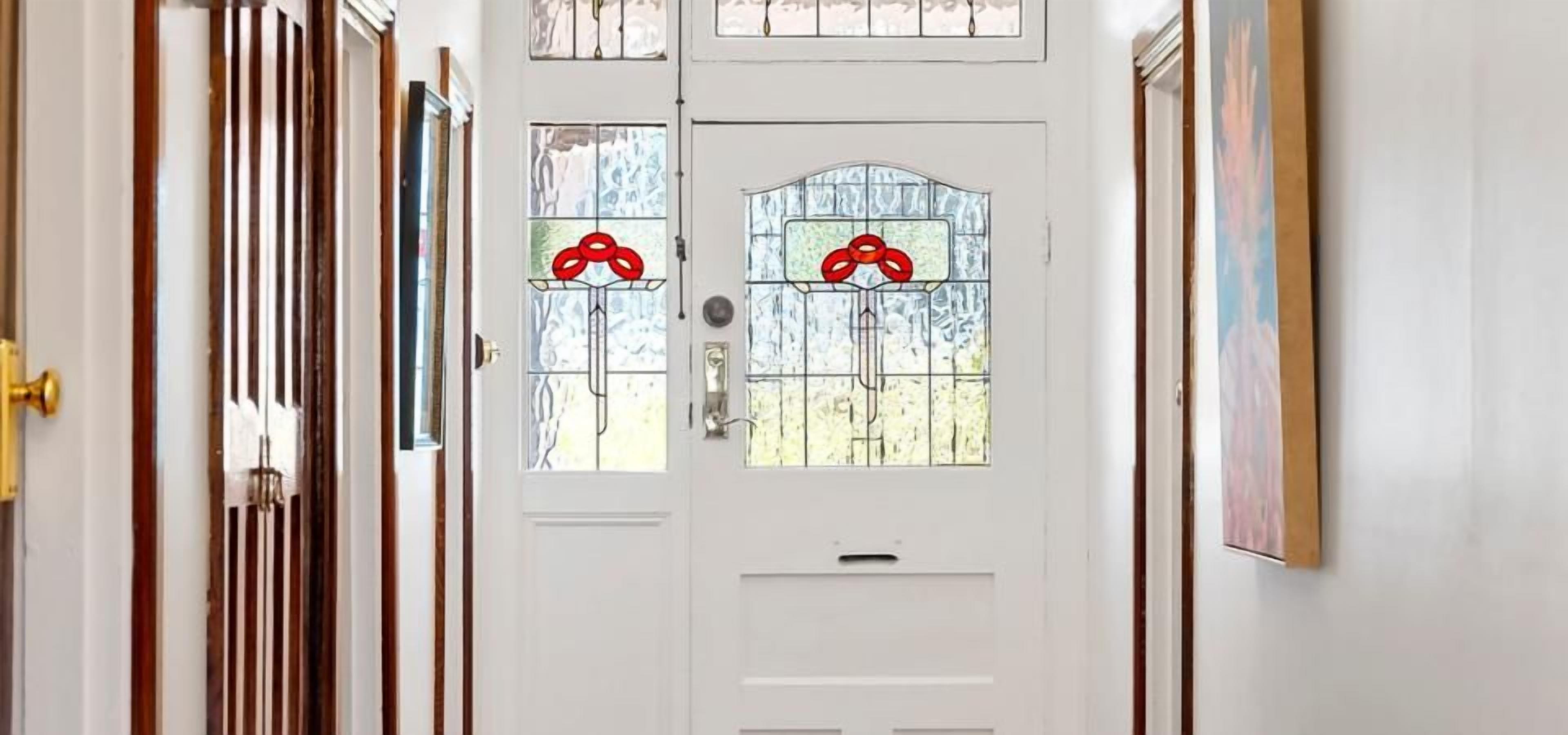 A white door with a small window and a handle.
