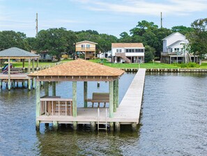 A wooden dock extending into a body of water with a gazebo structure at the end. - The Bay House - Soundfront, Dock, Gazebo, Close to Beach, Shops, Restaurants, Flex Stays (Kill Devil Hills)