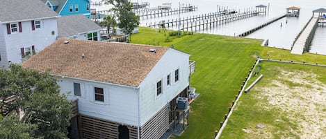 A residential area with a house, a dock, and a grassy yard.