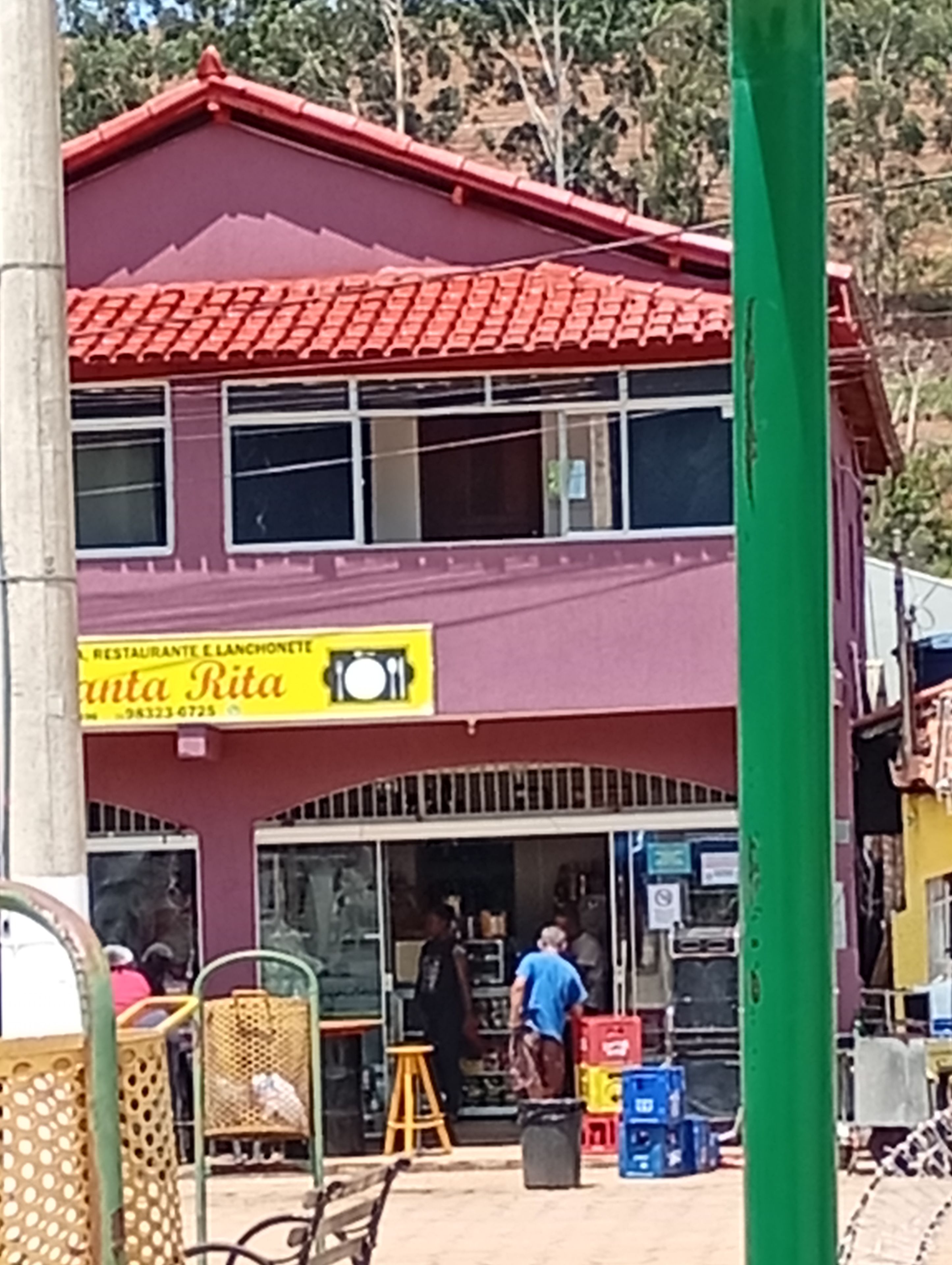 A two-story building with a red roof and a sign for 'Santa Rita Restaurant & Bar'.